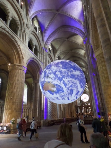 Durham Cathedral interior with a massive model of the Earth hanging from the ceiling