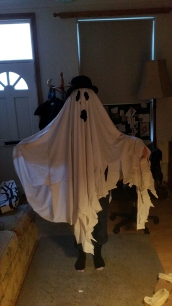 Your humble narrator dressed as a ghost, in a bedsheet and wearing a black hat